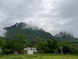 a mountain with clouds on top of it at พิงภู ไทรโยค in Ban Lum Sum (1)
