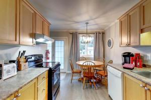 a kitchen with a table and a dining room at Wasaga Daze - Unit A in Wasaga Beach