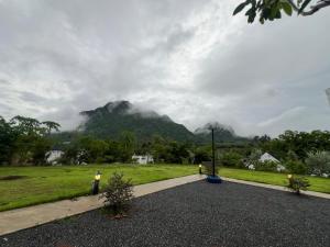a view of a mountain from a park with a road at พิงภู ไทรโยค in Ban Lum Sum (1)