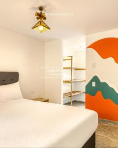 a bedroom with a bed and a ceiling fan at ÓRGANOS BEACH bungalows & suites in Los Órganos