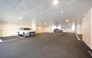 a garage with two cars parked in it at MH Hotel 3 - Junghwasan in Jeonju