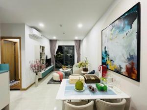 a living room with a large painting on the wall at Livahome - PDT Lux homestay Di An HCMC in Dĩ An