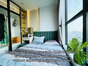 a bedroom with a bed and a large window at Livahome - PDT Lux homestay Di An HCMC in Dĩ An