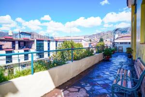 a balcony with benches and a view of a city at Mirador wayras in Cuzco
