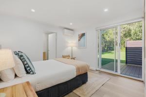 a bedroom with a bed and a large window at Ralph Escapes Yallingup in Yallingup +23 photos
