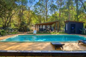 a swimming pool in a backyard with a house at Ralph Escapes Yallingup in Yallingup