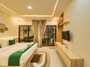 a bedroom with a bed and a flat screen tv at Sampai Villa Queensland in Pakem +23 photos