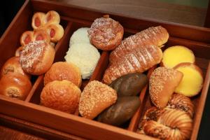 a wooden box filled with different types of donuts at Beijing Landmark Hotel in Beijing