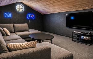 a living room with a couch and a tv at Nice Home In Hadsund With Sauna in Hadsund