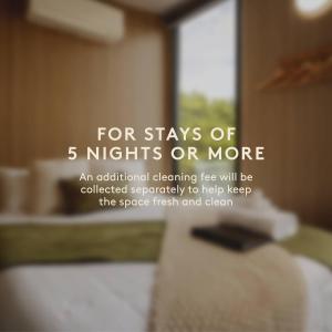 a sign that says for stays of nights or more at Bec's Place by Tiny Away in Fosterville