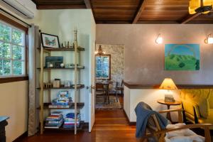 a living room with a yellow chair and a table at Wanderwood in Guerneville