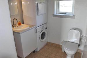 a bathroom with a toilet sink and a washing machine at FY296-Faaborg-Mosegarden-27 in Faaborg +10 photos