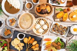 a table topped with plates of food and bowls of food at Hotel Gracery Osaka Namba in Osaka