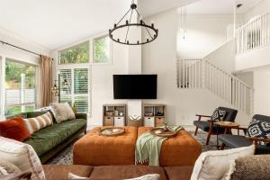 a living room with a couch and a tv at 6BR Pool & Game Arcade Family Dog Friendly in San Antonio