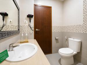 a bathroom with a white toilet and a sink at Eslem GuestHouse in Canggu +10 photos