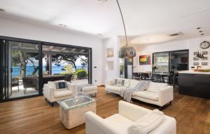 a living room with white furniture and a view of the ocean at Villa Ana in Jelsa