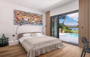 a bedroom with a bed and a large painting on the wall at Villa Ana in Jelsa