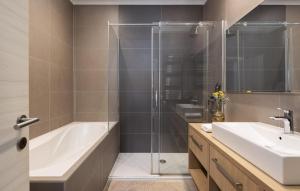 a bathroom with a shower and a tub and a sink at Villa Ana in Jelsa