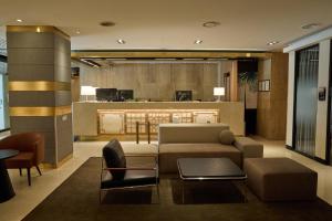 a living room with a couch and a table at Acube Hotel Dongdaemun in Seoul