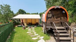 a tiny house in a yard with a tent at Hongcheon Opera Bien Glamping in Hongcheon