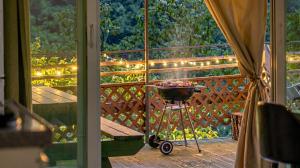 a wheelbarrow of fruit on a porch with lights at Hongcheon Opera Bien Glamping in Hongcheon +1 photo