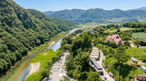 an aerial view of a river and mountains at Hongcheon Opera Bien Glamping in Hongcheon