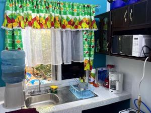a kitchen counter with a sink and a window at Casa Miramar Tx in Trujillo
