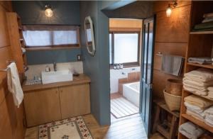 a bathroom with a tub and a sink and a toilet at cottonTSUKECHI in Nakatsugawa +34 photos