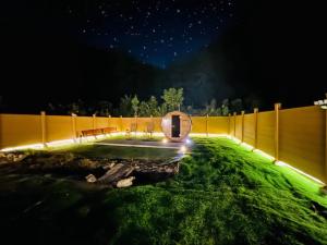 a backyard with a fence and a pond at night at 四季の庵 糸島 1300m2 大自然のパノラマ露天風呂 駐車場5台以上 サウナ 専用BBQ施設 ペット可 in Itoshima