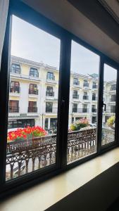 a window with a view of a building at Nomadtrails Boutique Sapa Hotel in Sapa