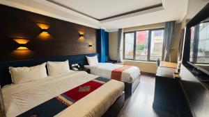 a hotel room with two beds and a window at Nomadtrails Boutique Sapa Hotel in Sapa +45 photos