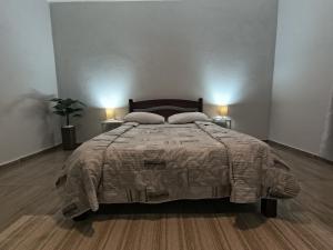 a bedroom with a bed with two pillows on it at Chácara com piscina e lazer em Avaré in Avaré
