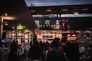 a crowd of people walking in front of a store at Hotel 二灯 in Beppu +42 photos