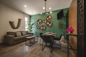 a living room with a couch and a table at Suites con piscina privada - Penca Suites Valladolid in Valladolid +6 photos