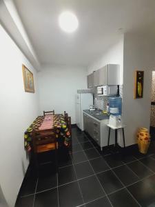 a kitchen with a table and a counter in it at Departamento Briana in Villa Unión