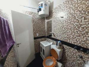 a small bathroom with a toilet and a sink at Departamento Briana in Villa Unión