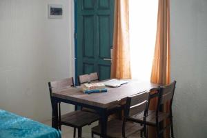 a dining room table with chairs and a green door at 1001 Nights Boutique Inn in Cagayan de Oro +38 photos