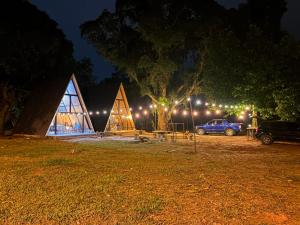 a group of tents in a field at night at Chalés parada ideal in Guapimirim