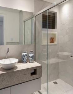 a bathroom with a sink and a glass shower at Quarto Aconchegante em Residência Familiar in São José