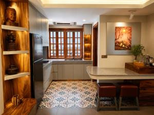 a kitchen with a counter and a table and chairs at Dynasty Boutique Hotel in Phnom Penh