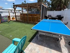 a ping pong table and chairs in a backyard at Sunset by the Sea 3054 in Fort Myers Beach