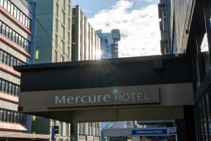 a sign for a mercure hotel in a city at Mercure Wellington Abel Tasman in Wellington