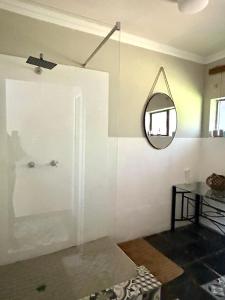 a white room with a mirror and a table at SPAat343 in Roodeplaat