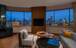 a living room with a view of a city at Millennium Hilton Bangkok in Bangkok