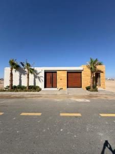 a building with palm trees in front of a street at رجبانية in Jeddah