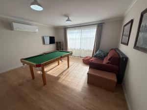 a living room with a pool table and a couch at Parsee Escape in Edithburgh