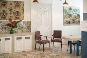 a kitchen with a table and two chairs and a table at 1001 Nights Boutique Inn in Cagayan de Oro