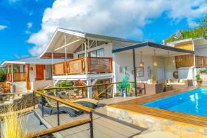 a house with a swimming pool and a patio at Tahai Loft Apart Hotel in Hanga Roa