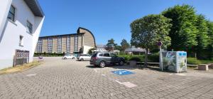 a car parked in a parking lot next to a building at Le Cocon des Sables in Sangatte