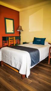 a bedroom with a bed with a blue pillow on it at Mirador wayras in Cuzco